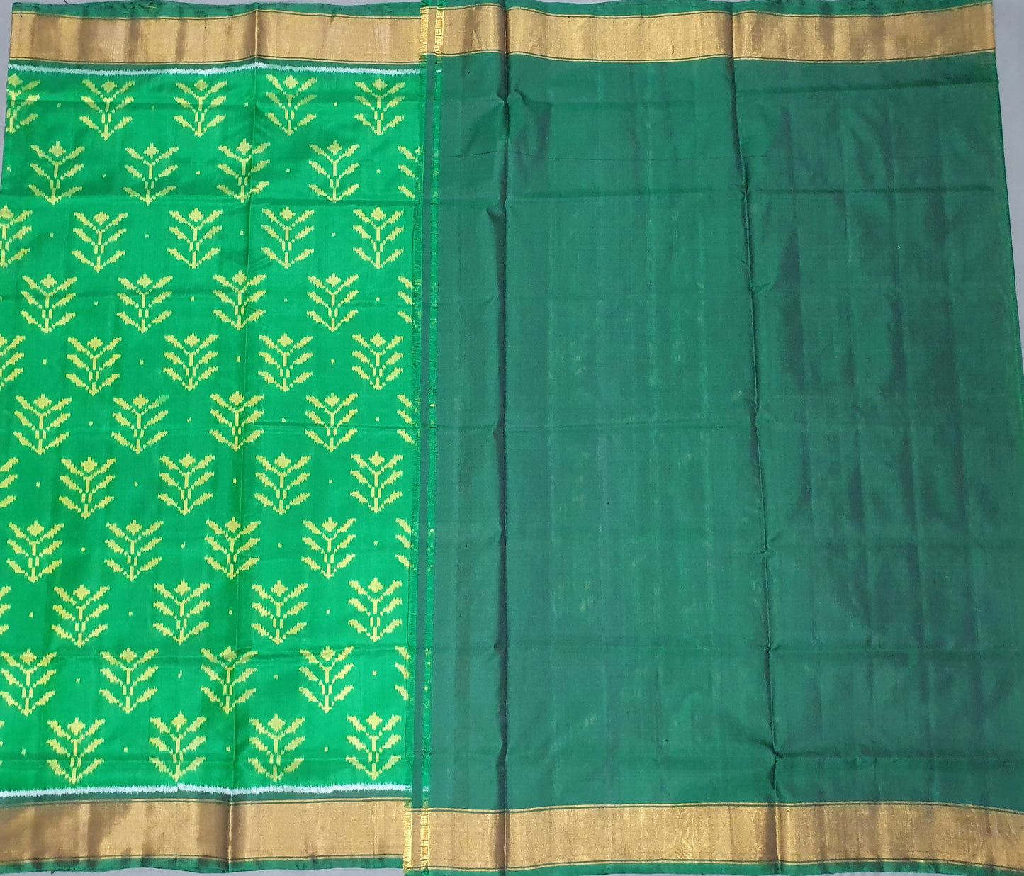 Green fabric with yellow pattern on a gray background
